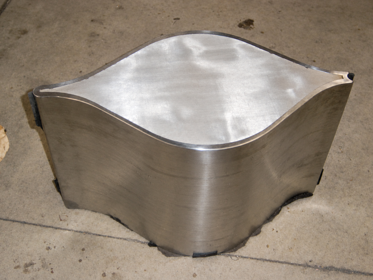 An early silver Flosion prototype with a white leaf-shaped upholstered top