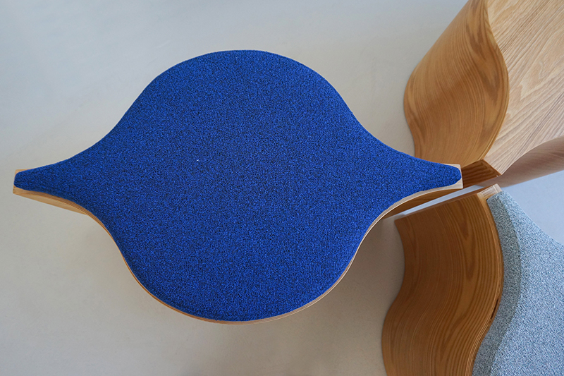 Close view of Flosion's upholstered top, layered bent-plywood edge and meeting curves