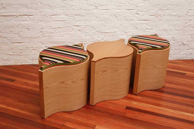 Flosion stools with striped textile tops beside a timber table
